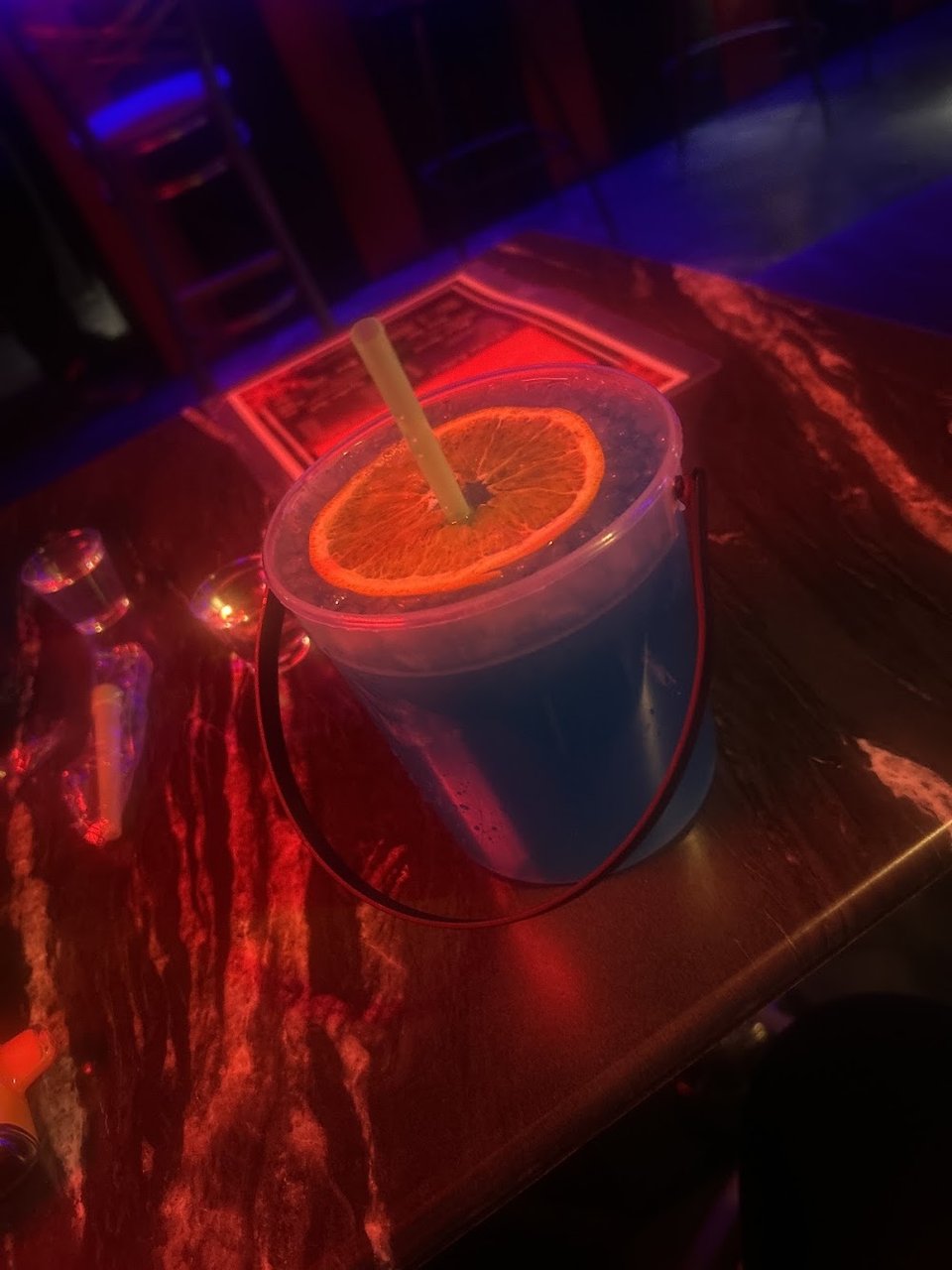 Cocktail menu beside a dimly lit table.